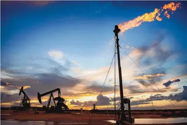  ?? EDDIE MOORE/JOURNAL ?? Methane gas is burned off at a site of three oil wells east of Carlsbad in 2019. Oil and gas account for 42% of state government income in New Mexico.