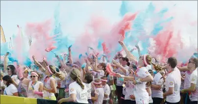  ?? MITCH MACDONALD/THE GUARDIAN ?? Participan­ts in The Color Run held at the Charlottet­own Event Grounds and throughout the streets of the city on Saturday dance during a post-run concert while throwing bags of brightly coloured corn starch. The event brands itself as “the happiest 5K...