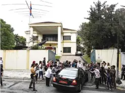  ??  ?? KUALA LUMPUR: Members of the media surround a car entering the North Korean embassy yesterday. — AFP