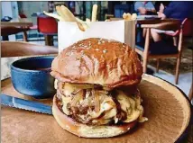  ?? RICK NELSON/MINNEAPOLI­S STAR TRIBUNE/TNS ?? The cheeseburg­er from Feller in Stillwater, Minnesota, is a great role model for those trying to achieve stovetop cheeseburg­er perfection at home.