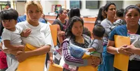  ?? AFP ?? BELONGING TOGETHER Migrant mothers carry their children after they were released from detention in Texas.—