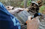  ?? HYOSUB SHIN / HSHIN@AJC.COM 2014 ?? Joel Slaton, who started Doll’s Head Trail, helps maintain its “found art” pieces at Constituti­on Lakes Park near the intersecti­on of South River Industrial Boulevard and Moreland Avenue.