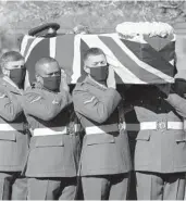  ?? JOE GIDDENS/POOL ?? The coffin of Captain Tom Moore is carried by Armed Forces members Saturday in Bedford, England.