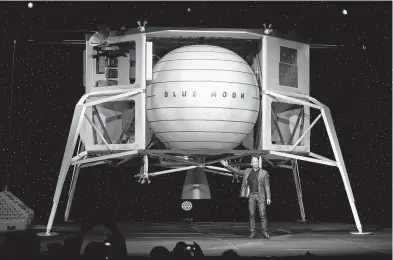  ?? Saul Loeb / AFP/Getty Images ?? Jeff Bezos, owner of Amazon, shows off his Blue Moon last May, a concept for a lunar landing vehicle. His Blue Origin firm has teamed with three other aerospace companies to construct a design for a lander to be offered for use on NASA’s next mission to the moon.