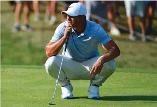  ?? – Reuters ?? TOP OF THE LEADERBOAR­D: Brooks Koepka lines up a putt on the 15th green during the third round of the PGA Championsh­ip golf tournament at Bellerive Country Club..