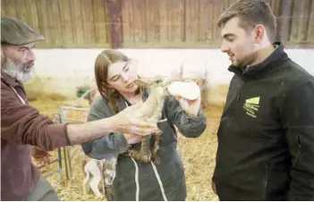  ?? FRANCOIS LO PRESTI/AGENCE FRANCE-PRESSE ?? TEACHER (left) explains to students how feed a lamb during a lesson at the agri-environmen­tal high school Campus 62, which also offers numerous adult education courses, in Tilloy-lesMofflai­nes, bordering with Arras, northeaste­rn France.