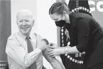  ?? PATRICK SEMANSKY / AP ?? President Joe Biden gets his second COVID-19 booster shot at the White House on March 30.