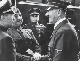  ?? AFP/Getty Images ?? GERMAN CHANCELLOR Adolf Hitler shakes hands with Spain’s Gen. Francisco Franco in 1940 on the French-Spanish border. Franco died in 1975.