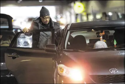  ?? BRANDEN CAMP / SPECIAL ?? Troy Moore gets into an Uber driver’s car at the designated ride-share area at Hartsfield-Jackson Atlanta Internatio­nal Airport in Atlanta. Taxi drivers have seen their business drop.