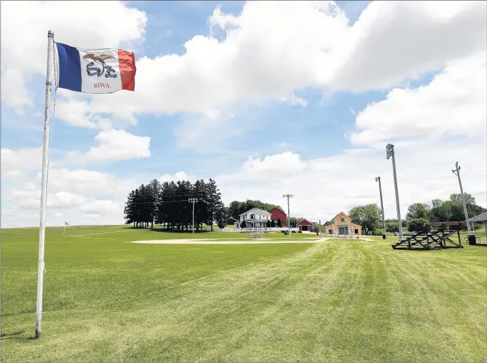  ?? CHARLIE NEIBERGALL/AP ?? An Iowa flag waves in the wind over the field at the Field of Dreams movie site, Friday, June 5, 2020, in Dyersville, Iowa. MLB is hoping to stage a game in the area in August.