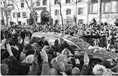  ??  ?? Daughters of late French singer Johnny Hallyday Jade (Left) and Joy (Right) Hallyday and his wife Laeticia Hallyday walk behind the hearse as it arrives at the La Madeleine Church for the funeral ceremony of late French singer Johnny Hallyday on Dec 9...