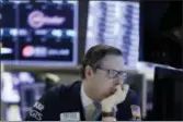  ?? RICHARD DREW — THE ASSOCIATED PRESS ?? Specialist Gregg Maloney works at his post on the floor of the New York Stock Exchange, Wednesday. It was another shaky day on Wall Street as indexes rallied in the morning, bobbed up and down for much of the day, then sank in the last few minutes of...