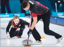  ?? CP PHOTO ?? Kaitlyn Lawes reacts as teammate John Morris sweeps during mixed doubles curling action against Norway at the Olympic Winter Games in Gangneung, South Korea, on Thursday. Canada lost 9-6.