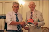  ??  ?? Christchur­ch’s David BolamSmith, right, presents a Crusaders cap and gifts to Ishinomaki Rugby Football Union chairman Katsuo Sasaki.