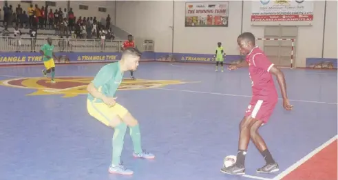  ?? - Picture by MICHAEL MIYOBA. ?? Jack Simwami of Automotive FC attempts to beat South Africa’s Yazeed Joharie during an internatio­nal friendly fixture at Automotive Futsal Arena.