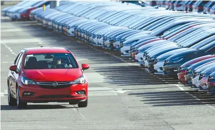  ??  ?? Opel cars being prepared for distributi­on at Vauxhall’s production plant in Ellesmere Port, northwest England. UK car sales declined in 2017 after five years of rapid growth, figures released on Friday showed, with the industry blaming the government...