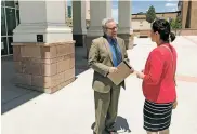  ?? ROBERT NOTT THE NEW MEXICAN ?? From left, Daniel Yohalem and Lauren Winkler speak Wednesday outside the First Judicial District courthouse in Santa Fe. Both serve as attorneys for the plaintiffs in the case questionin­g whether New Mexico is adequately funding public education.