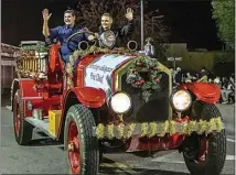  ?? NICK ELLIS / FOR THE CALIFORNIA­N / FILE ?? Bakersfiel­d Fire Department Chief Anthony Galagaza and others ride in an old fire engine during the Bakersfiel­d Christmas Parade in 2018. The event returns Dec. 2 as an in-person celebratio­n.