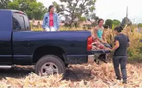  ?? COURTESY OF UNIVERSITY OF NEW MEXICO PRESS ?? Santa Clara Pueblo women gather near a truck during a corn harvest in 2014.