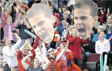  ??  ?? Fans wave cut- outs of Vasek Pospisil during Davis Cup play last month in Ottawa.