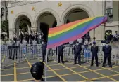  ?? — AFP ?? A supporter of same-sex marriage waves a flag outside the Judicial Yuan in Taipei on Friday.