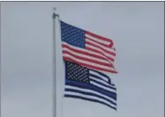  ?? JOSHUA WAGNER — MEDIANEWS GROUP ?? The American flag and the version of the Thin Blue Line flag that was once flying on the flag pole at the Madison County Jail. This flag has since been traded out for a different version.