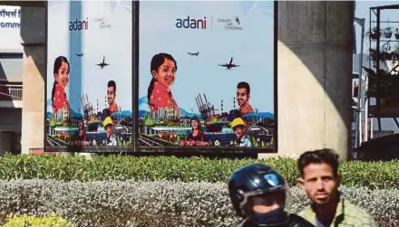  ?? AFP PIC ?? Adani group shares fell yesterday after the conglomera­te shelved a US$2.5 billion share sale amid a turbulent market.