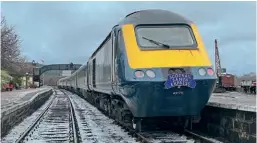  ?? David Green ?? With a light covering of snow adding to the atmosphere, Scotrail Inter7city HST – formed of 43175 and 43179 and five Mk.3 HST trailers – stands at Boat of Garten station on December 4, 2021, after arrival from Edinburgh Waverley.