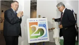 ?? — PRITAM BANDYOPADH­YAY ?? MEA secretary (economic relations) Amar Sinha (right) with Israeli ambassador to India Daniel Carmon in New Delhi on Tuesday, during the unveiling of a logo to mark 25 years of India-Israel diplomatic relations.