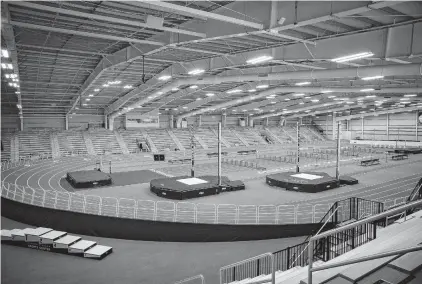  ?? KRISTEN ZEIS/STAFF ?? The new, 200-meter hydraulic indoor track at Virginia Beach Sports Center can be raised or lowered for banked corners. In the middle are eight lanes for sprints and hurdles, long- and triple-jump runways and two runways for the pole vault. The high-jump area is at one of the ends.