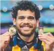  ??  ?? Cyril Rioli with his 2015 Norm Smith and premiershi­p medals.