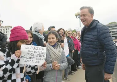  ?? DOUGLAS HEALEY/SPECIAL TO THE COURANT ?? Gov. Ned Lamont joins protesters during a May 8 reproducti­ve rights rally in Westport held in the wake of a leaked draft of a U.S. Supreme Court opinion that would overturn the Roe v. Wade decision that protected abortion rights.