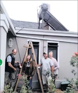  ?? PICTURE: INDEPENDEN­T MEDIA ?? Durban resident Raymond Auerbach with a solar-powered water heater which was installed by and Ian and Natasha Strydom.