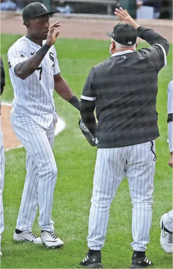  ?? GETTY IMAGES ?? Tim Anderson is congratula­ted by manager Rick Renteria after the Sox defeated the Twins.
