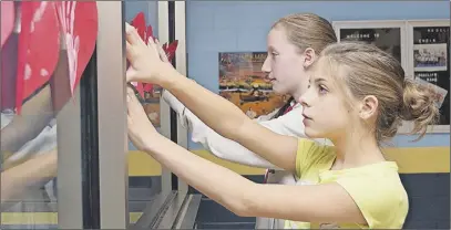  ?? RaIssa TeTaNIsh/TC MedIa ?? Mackenzie Boyd, foreground, and Hannah Hominick are just two members of the World Changers at Redcliff Middle School. The group has been hosting fundraiser­s almost monthly for local and internatio­nal causes.