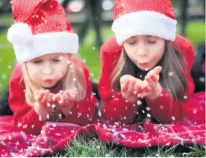  ??  ?? Making a wish Olivia, four, and Nikola, eight, have festive fun in the park