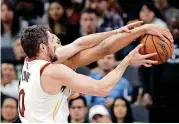  ?? [PHOTO ?? Cleveland Cavaliers forward Kevin Love (10) battles San Antonio Spurs forward Kyle Anderson for a rebound during Tuesday night’s 114-102 win by the Spurs.