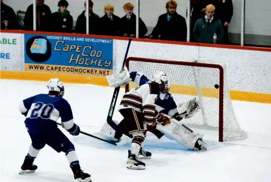  ?? PAT GREENHOUSE/GLOBE STAFF ?? Cam Melone lifts one past Stoneham goalie Jacob Utter in double overtime to send Hanover to its fifth state final in 11 years.