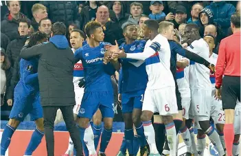  ??  ?? Everton and Lyon players clash in their Uefa Europa League Group E match at the Goodison Park in Liverpool on Thursday. Lyon won 2-1. —