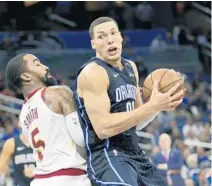  ?? JOHN RAOUX/AP ?? The Orlando Magic’s Aaron Gordon, right, makes a move to get past the Cleveland Cavaliers’ J.R. Smith on Monday night. The Magic are trying to avoid letdowns and build on their two-game winning streak.