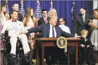  ?? Tribune News Service ?? President Donald Trump reacts after signing into law the “Right to Try Act” intended to expand access by terminal patients to investigat­ional drugs on May 30.