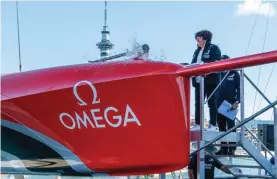  ??  ?? Lady Margaret Tindall christens the Emirates Team New Zealand America's Cup AC75 boat 2