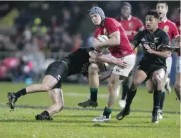  ??  ?? ROTORUA: British & Irish Lions player Jonathan Davies is tackled by a New Zealand Maori player during their match in Rotorua, New Zealand, yesterday. — AP