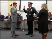  ?? MEDIANEWS GROUP FILE PHOTO ?? New Lansdale Police Chief Michael Trail is sworn in by Lansdale Mayor Garry Herbert on March 28, 2018. His wife, Grace, is holding the Bible.