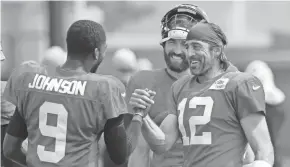  ?? DAN POWERS/USA TODAY NETWORK-WISCONSIN ?? Jets quarterbac­k Josh Johnson (9) greets Packers quarterbac­k Aaron Rodgers (12) during training camp Wednesday.