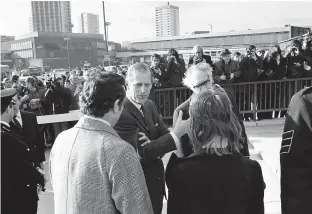  ??  ?? > Prince Philip visiting the Mulberry Bush pub on November 25, 1974 after the IRA bomb – talking with landlord David Jones and wife Maura Jones, who was in the pub