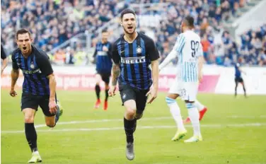  ?? Associated Press ?? Inter Milan’s Matteo Politano (centre) reacts after scoring his side’s opening goal against Spal on Sunday.