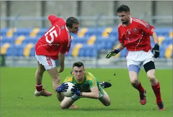  ??  ?? Laragh’s David McDonald is stopped by Valleymoun­t’s James Fitzpatric­k. Photo: Garry O’Neill