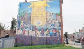  ??  ?? A mural on Greenmount Avenue near 27th Street honors the Harwood neighborho­od.