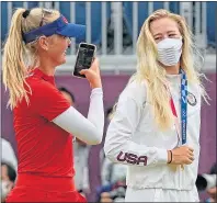  ??  ?? Jessica Korda takes a picture of little sister Nelly with her Olympic gold yesterday